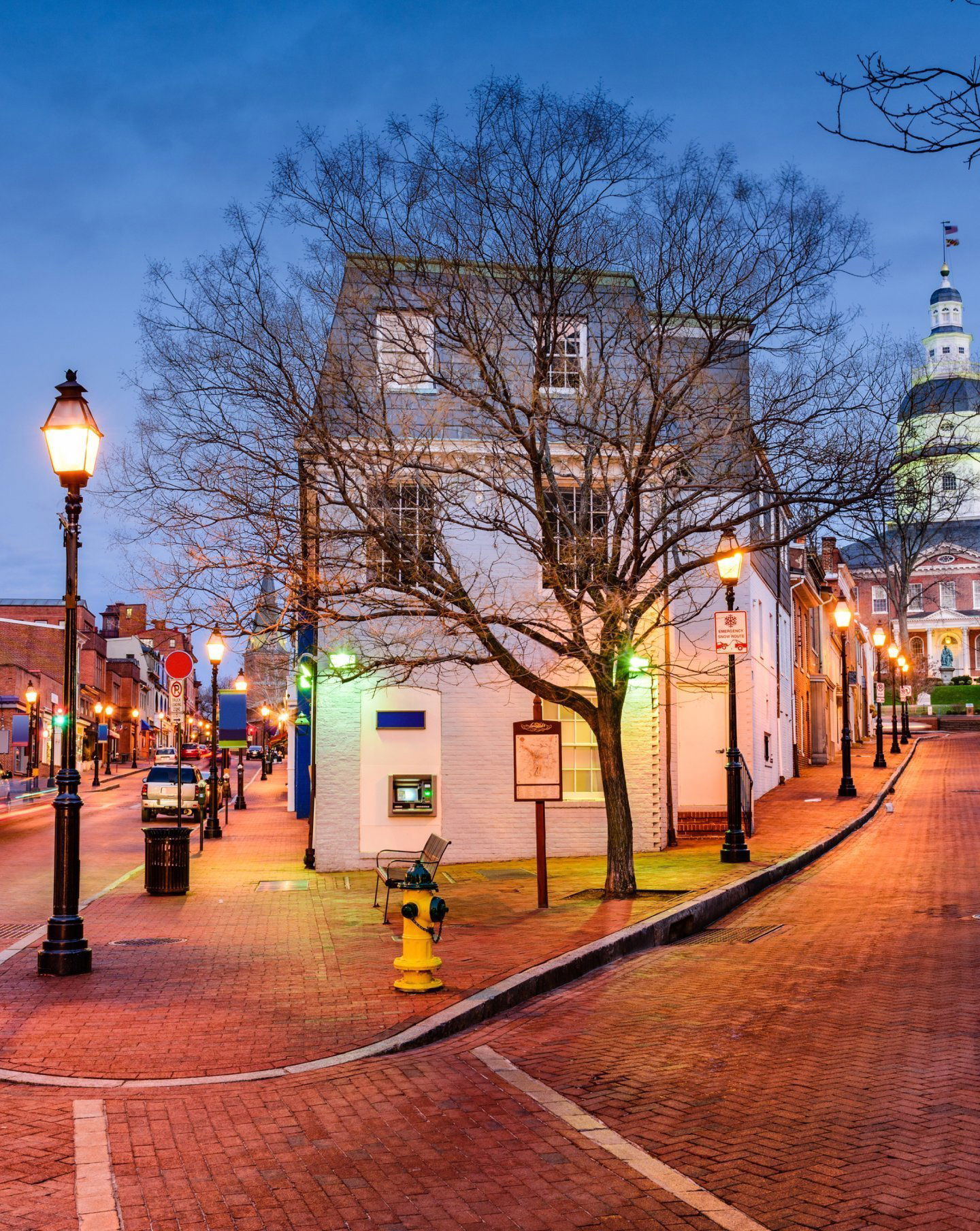 Downtown Maryland at night with street lamps all lit
